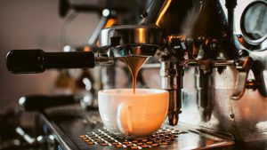 espresso machine pouring coffee into cups