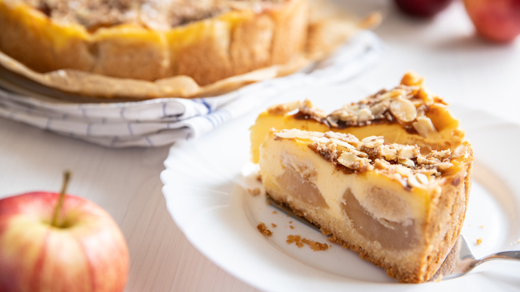 Zwei Stücke Apfel-Schmand-Kuchen stehen auf einem weißen Teller.